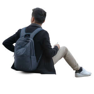 asian man sitting on a sidewalk