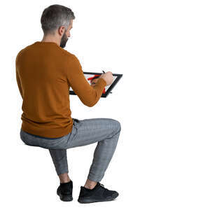 man sitting and drawing on computer
