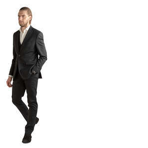 man in a suit walking with his hand in his pocket