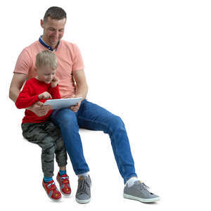father and son sitting and watching smth from tablet