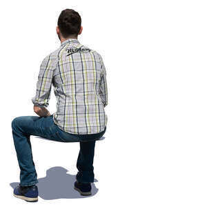 man sitting in sunlight seen from behind