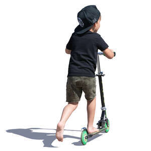 little boy with a hat riding a scooter
