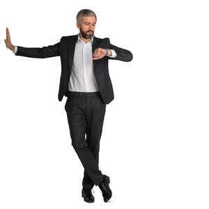 man in a suit leaning against the wall