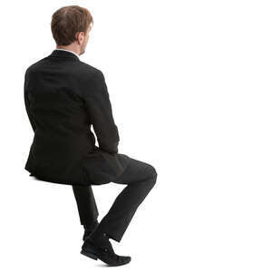 man in a black suit sitting