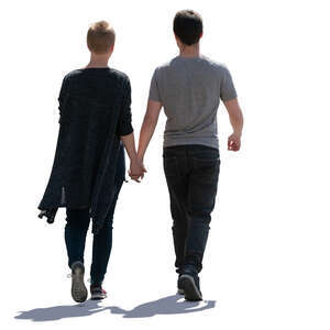 backlit couple walking hand in hand
