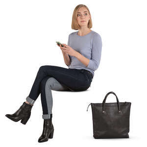 woman with a phone in her hand sitting and looking up