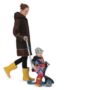 mother pushing her son on a baby scooter