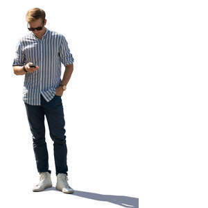 backlit mand standing and text messaging