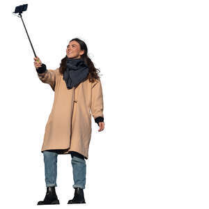 woman standing and taking a selfie seen from below