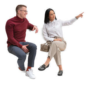 man and woman sitting and looking at smth