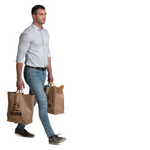 man with two big grocery bags walking