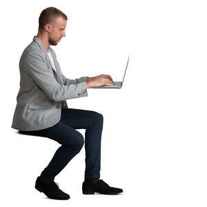 man sitting and working with laptop at the desk