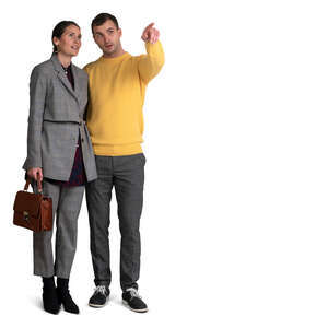 couple standing and pointing at smth