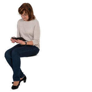 senior woman sitting and looking at her phone