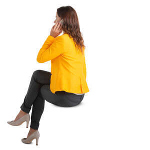 woman sitting and talking on a phone