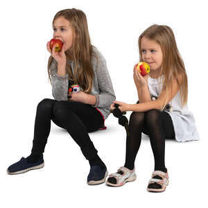 two girls sitting and eating apples