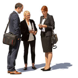 group of three business people standing outside