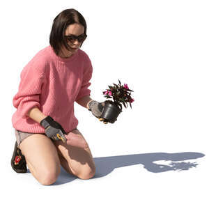 woman planting a flower in the garden