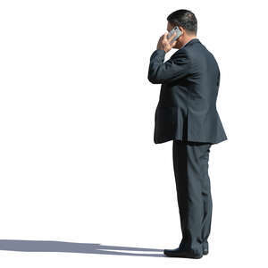 asian businessman standing and talking on a phone