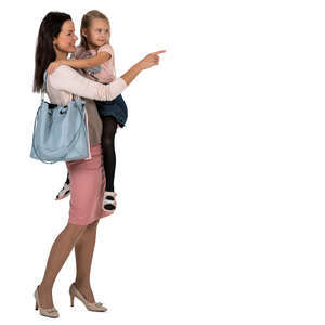 woman holding a child standing and pointing at smth