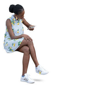 woman in a summer dress sitting and texting