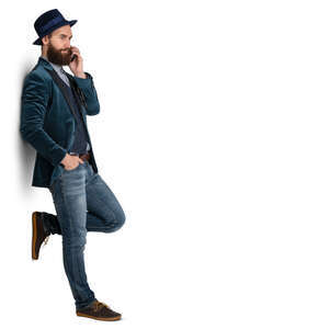 trendy man standing and leaning against the wall