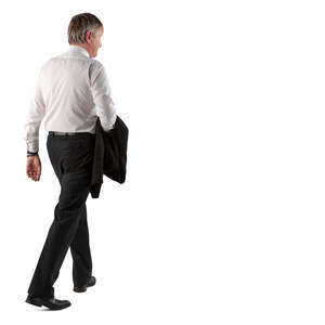 man in a suit walking and carrying his jacket