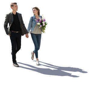 backlit couple walking hand in hand