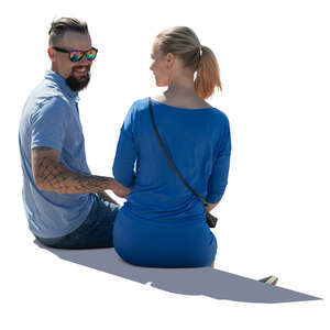 backlit man and woman sitting and talking