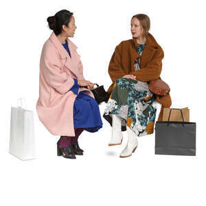 cut out two women in overcoats sitting and talking