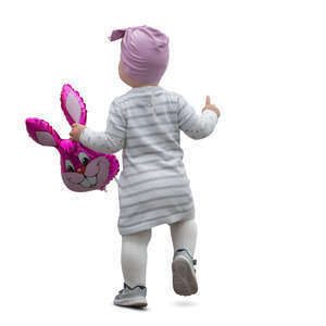 cut out toddler with a toy in her hand walking