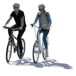 cut out backlit image of a man and woman riding a bike