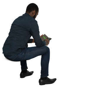 cut out black man sitting and checking his phone