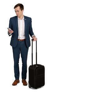cut out young travelling businessman standing and looking at his phone