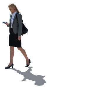 cut out backlit businesswoman with a phone in her hand walking