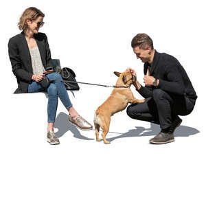 cut out man and woman sitting and petting  a small dog