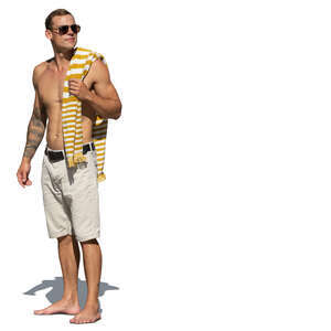 cut out man with a towel over his shoulder standing at the beach