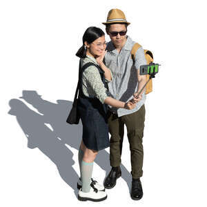 cut out asian man and woman standing and taking a selfie seen from above