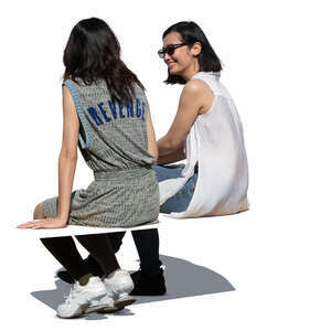 two cut out asian women sitting and talking