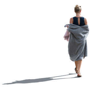 cut out backlit woman with a grey summer overcoat walking