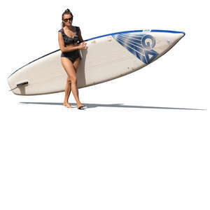 cut out woman with a sup board walking on the beach