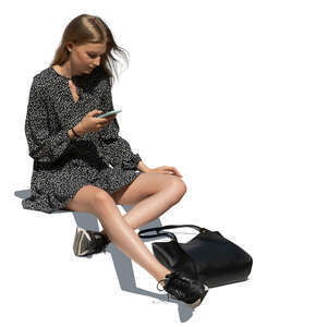 cut out young woman sitting on the stairs and looking at her phone
