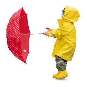 cut out child in a yellow raincoat standing and holding a red umbrella on a windy day