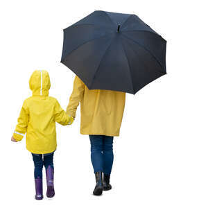 mother and daughter in yellow raincoats walking hand in hand on a rainy day