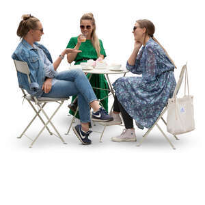 three cut out young women sitting in a cafe and talking