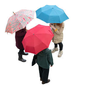 three cut out women with umbrellas standing seen from above
