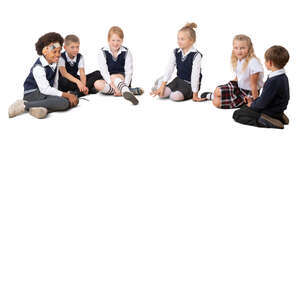 six cut out schoolchildren sitting on the ground in a circle