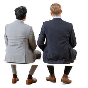 two cut out businessmen sitting seen from behind