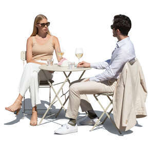 cut out man and woman sitting in a street cafe and drinking wine
