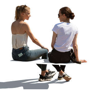 two cut out  women sitting and talking seen from behind